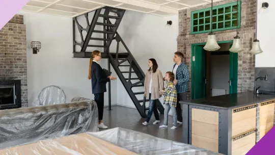 Couple with a child having a conversation with a realtor, illustrating the need to evaluate your options before deciding whether to rent or buy a house