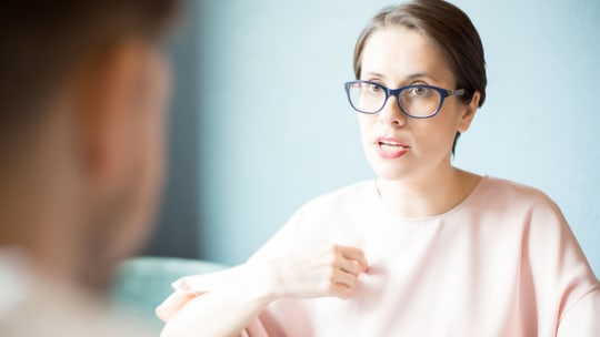 Woman with glasses speaking