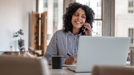 Woman smiling on her laptop