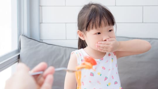 Girl who doesn't want to eat her food