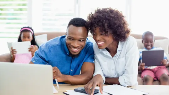 couple creating a family emergency plan while kids sit behind them