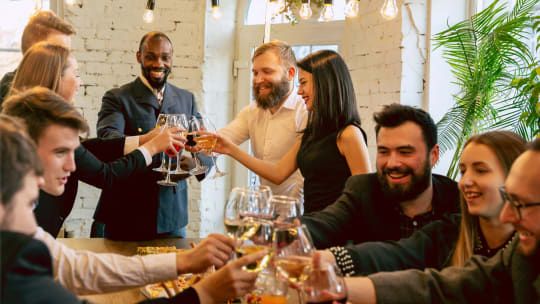 colleagues toasting with wine glasses at a work party 