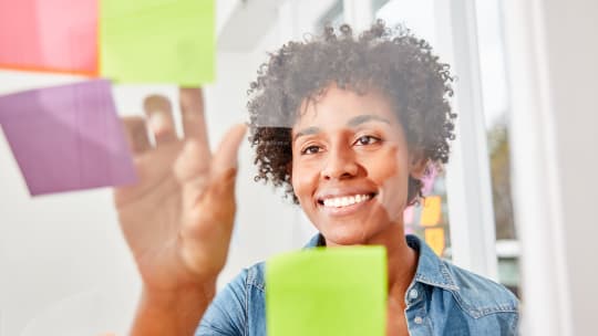 woman reading Post-It notes