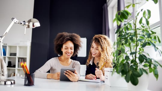 Two women looking at screen