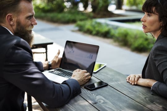 Business meeting, man and woman, outside