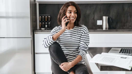 woman in her kitchen on the phone