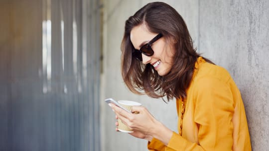 Woman Laughing at Phone