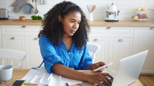Woman looking at bills