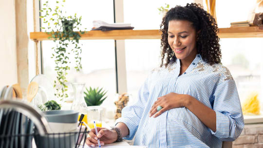 Pregnant woman writing