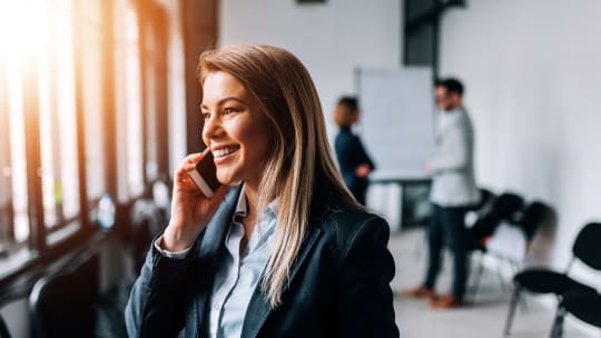 business person smiling on the phone
