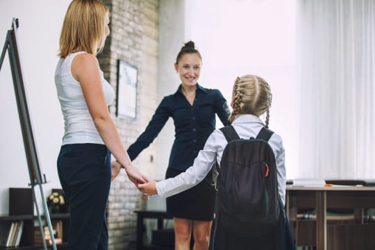 Parent with child and teacher