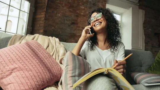 woman lounging on the couch on the phone