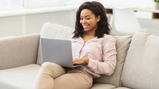 Woman on couch with laptop