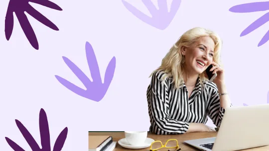 two women holding resumes in an interview setting