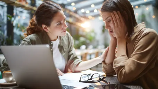 Woman comforting coworker