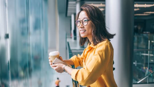 woman daydreaming in office building