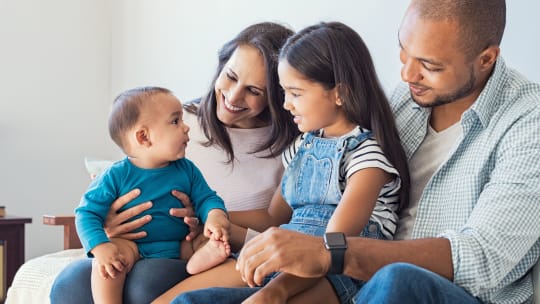 Happy family with good family leave policies