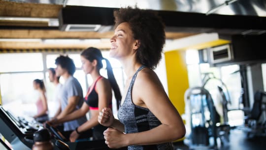 woman running on the treadmill at a gym
