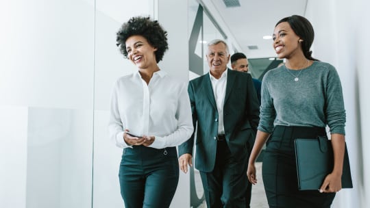 Team of corporate professionals in office corridor