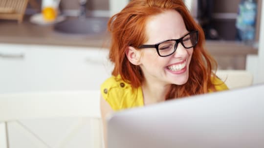 Woman Laughing at Computer
