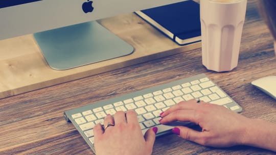 woman's hands typing