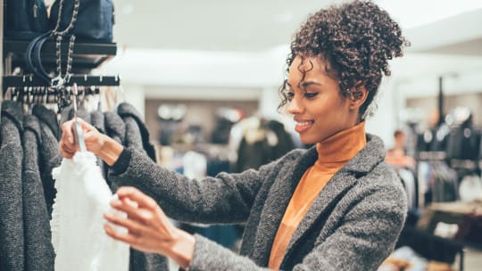 woman looking at clothes in a store