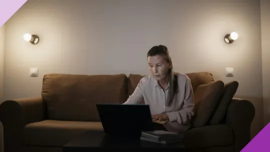 A senior woman learning about investments after retirement in her laptop