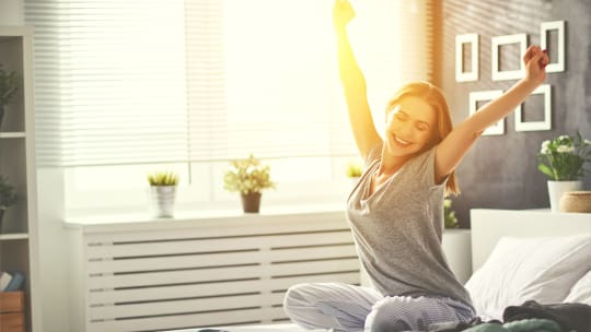 woman stretching in bed