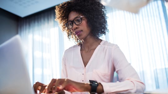 woman typing business plan