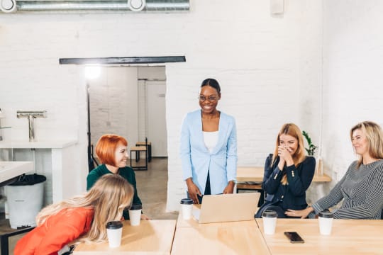 Coworkers smile around a table