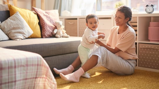 woman playing with a baby