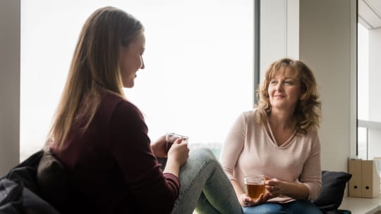 mother and daughter having tea