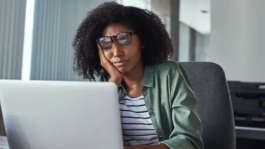 Woman on laptop frustrated