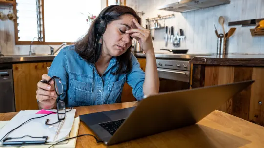 Woman on laptop in kitchen