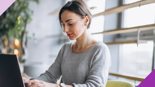 A woman writing her self-evaluation to illustrate how reading these nine self-evaluation examples can help you write yours