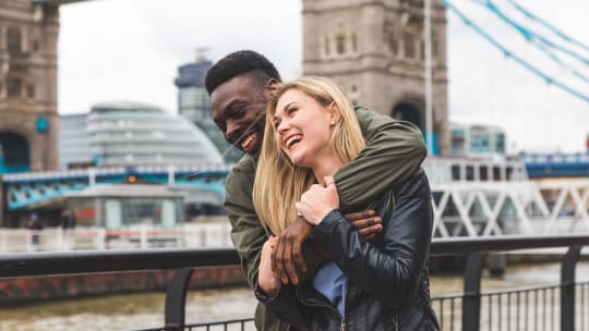 happy couple hugging and laughing in London