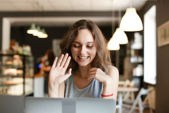 Woman with no makeup on reading her laptop