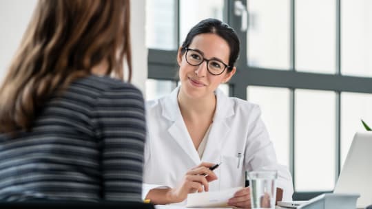 proctologist talking with patient