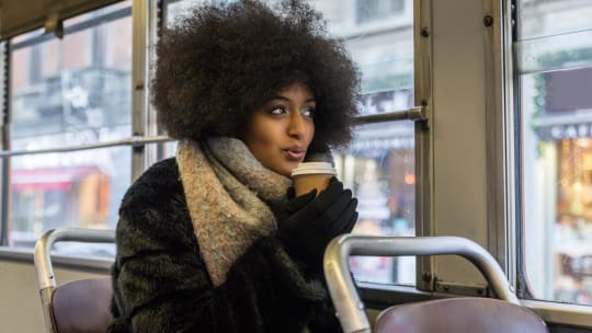 Woman in jacket with coffee