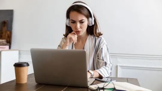 Serious woman writing resume
