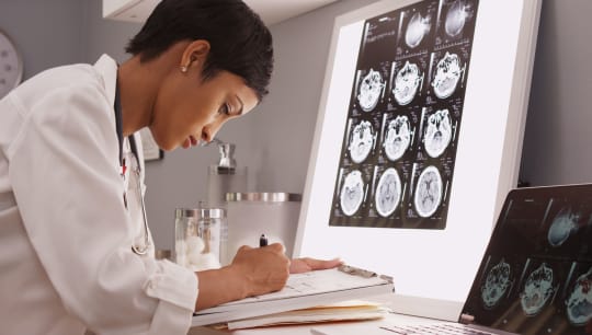 woman looking at brain scans