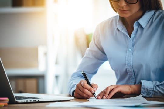 Woman Signing Paperwork