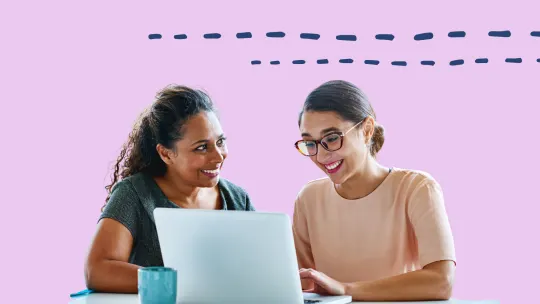 two women working together at a desk
