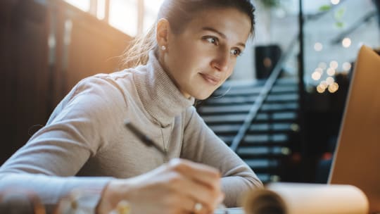 Woman writing in notebook