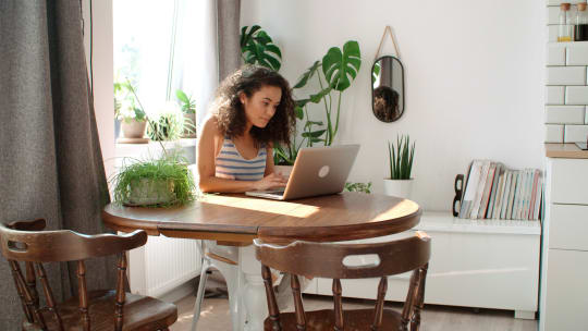 woman sitting at table typing