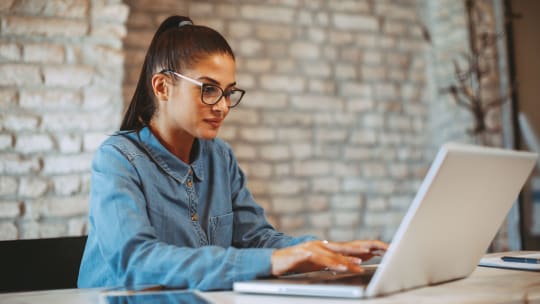 Young woman working on laptop in the office