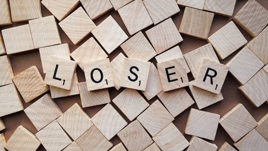 scrabble pieces spelling "loser"