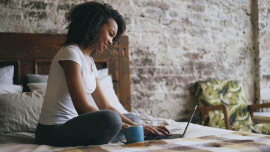 woman typing certifications on a resume