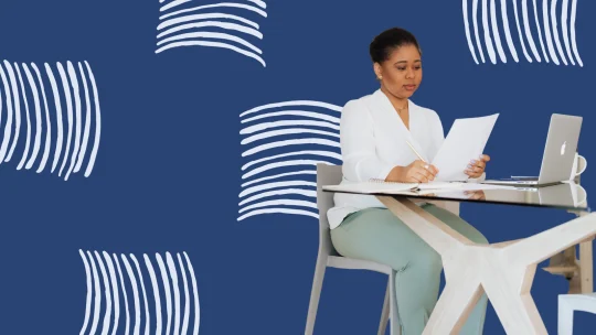 woman reviewing paper at desk