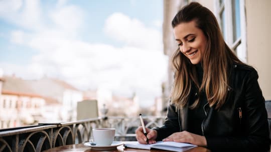 Woman writing in notebook